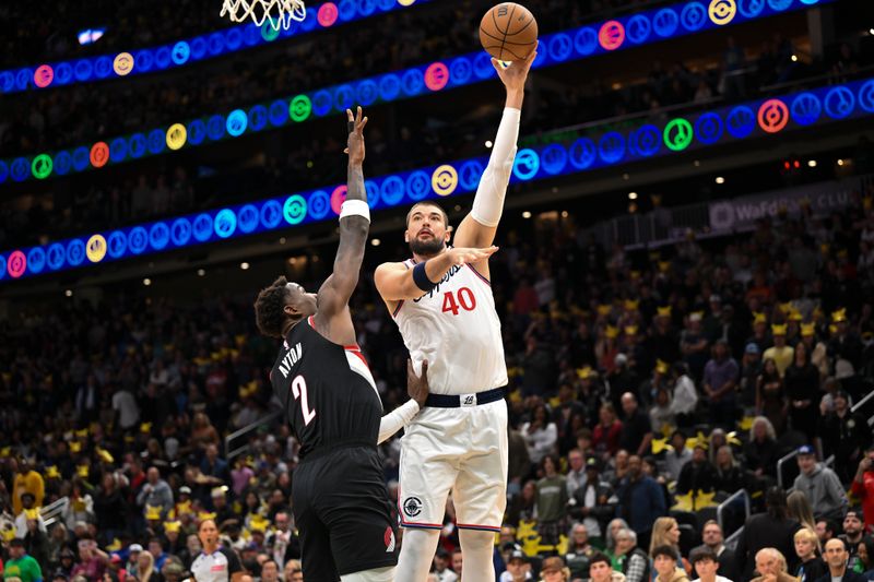 SEATTLE, WASHINGTON - OCTOBER 11: Ivica Zubac #40 of the LA Clippers shoots against Deandre Ayton #2 of the Portland Trail Blazers during the first quarter of the Rain City Showcase game at Climate Pledge Arena on October 11, 2024 in Seattle, Washington. NOTE TO USER: User expressly acknowledges and agrees that, by downloading and or using this photograph, User is consenting to the terms and conditions of the Getty Images License Agreement. (Photo by Alika Jenner/Getty Images)