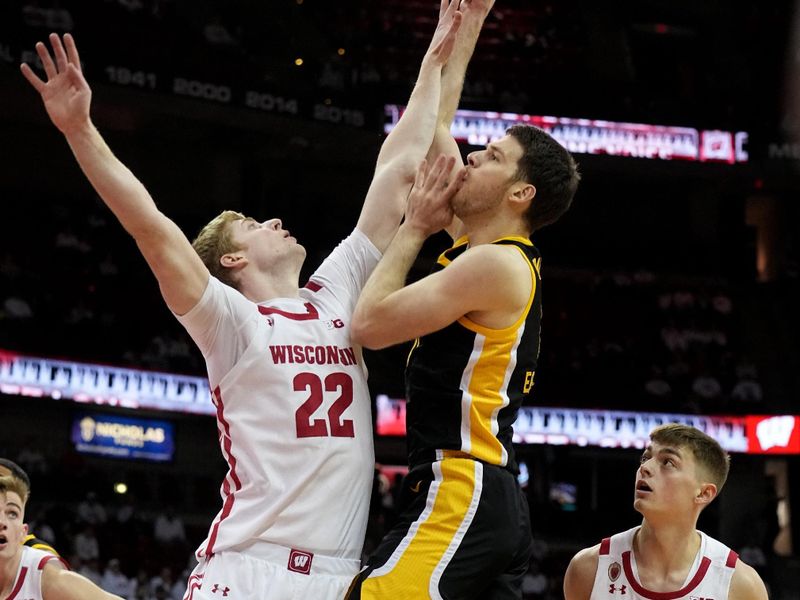 Feb 22, 2023; Madison, Wisconsin, USA; Wisconsin forward Steven Crowl (22) fouls Iowa guard Connor McCaffery (30) during the first half at Kohl Center. Mandatory Credit: Mark Hoffman-USA TODAY Sports