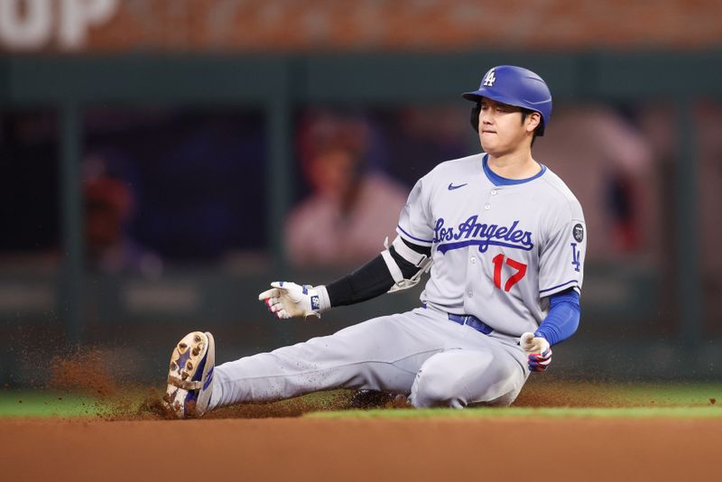 May 4, 2025; Atlanta, Georgia, USA; Los Angeles Dodgers designated hitter Shohei Ohtani (17) slides into second base against the Atlanta Braves in the seventh inning at Truist Park. Mandatory Credit: Brett Davis-Imagn Images