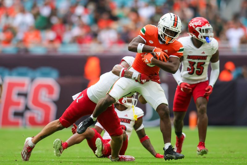 Nov 18, 2023; Miami Gardens, Florida, USA; Miami Hurricanes wide receiver Brashard Smith (0) runs with the football against the Louisville Cardinals during the fourth quarter at Hard Rock Stadium. Mandatory Credit: Sam Navarro-USA TODAY Sports