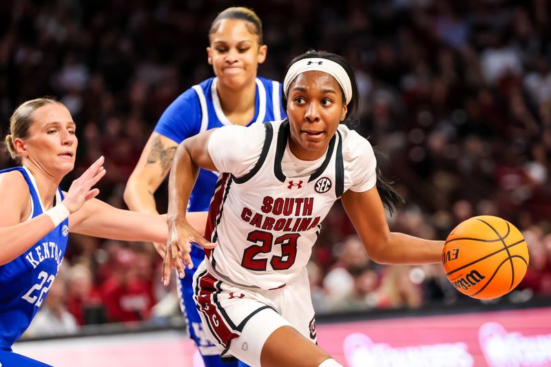 Jan 15, 2024; Columbia, South Carolina, USA; South Carolina Gamecocks guard Bree Hall (23) drives around Kentucky Wildcats guard Maddie Scherr (22) in the first half at Colonial Life Arena. Mandatory Credit: Jeff Blake-USA TODAY Sports