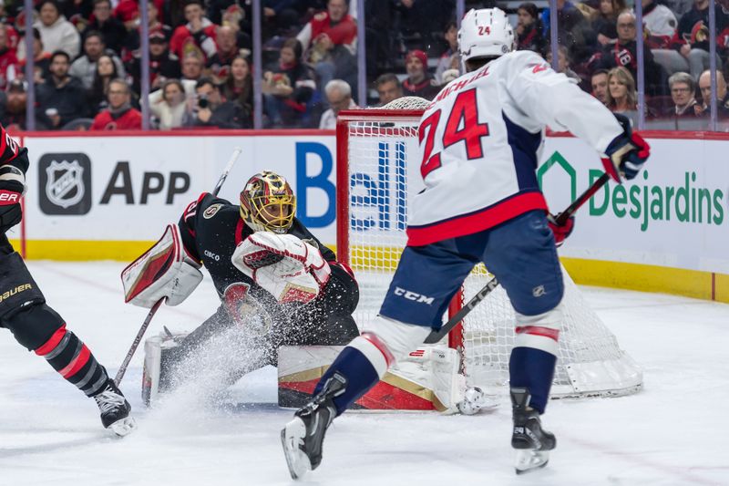 Jan 30, 2025; Ottawa, Ontario, CAN; Washington Capitals center Connor McMichael (24) scores against Ottawa Senators goalie Anton Forsberg (31) in the second period at the Canadian Tire Centre. Mandatory Credit: Marc DesRosiers-Imagn Images