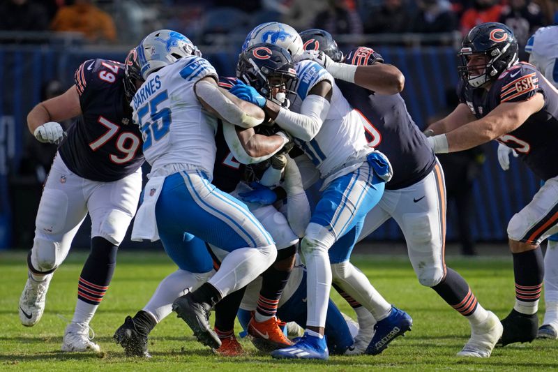 Chicago Bears running back Khalil Herbert (24) is tackled by Detroit Lions defenders during the second half of an NFL football game, Sunday, Nov. 13, 2022 in Chicago. The Lions won 31-30. (AP Photo/Nam Y. Huh)