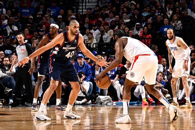 PHILADELPHIA, PA - MARCH 27:  Nicolas Batum #40 of the Philadelphia 76ers plays defense against James Harden #1 of the LA Clippers during the game on March 27, 2024 at the Wells Fargo Center in Philadelphia, Pennsylvania NOTE TO USER: User expressly acknowledges and agrees that, by downloading and/or using this Photograph, user is consenting to the terms and conditions of the Getty Images License Agreement. Mandatory Copyright Notice: Copyright 2024 NBAE (Photo by David Dow/NBAE via Getty Images)