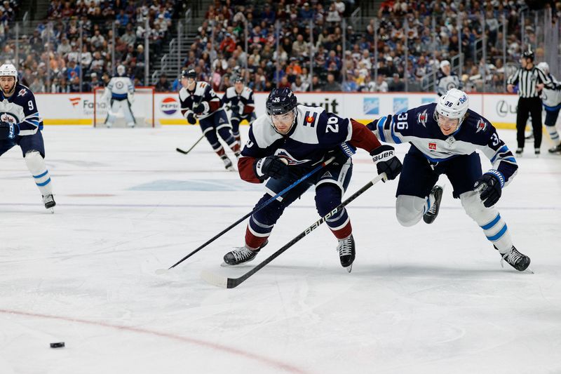 Apr 13, 2024; Denver, Colorado, USA; Colorado Avalanche defenseman Sean Walker (26) and Winnipeg Jets center Morgan Barron (36) chases down a loose puck in the first period at Ball Arena. Mandatory Credit: Isaiah J. Downing-USA TODAY Sports