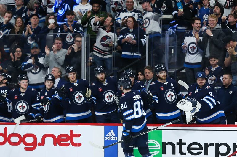 Jan 6, 2023; Winnipeg, Manitoba, CAN;  Winnipeg Jets forward Pierre-Luc Dubois (80) is congratulated by his team mates on his goal against the Tampa Bay Lightning during the second period at Canada Life Centre. Mandatory Credit: Terrence Lee-USA TODAY Sports