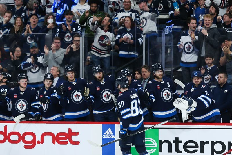 Jan 6, 2023; Winnipeg, Manitoba, CAN;  Winnipeg Jets forward Pierre-Luc Dubois (80) is congratulated by his team mates on his goal against the Tampa Bay Lightning during the second period at Canada Life Centre. Mandatory Credit: Terrence Lee-USA TODAY Sports