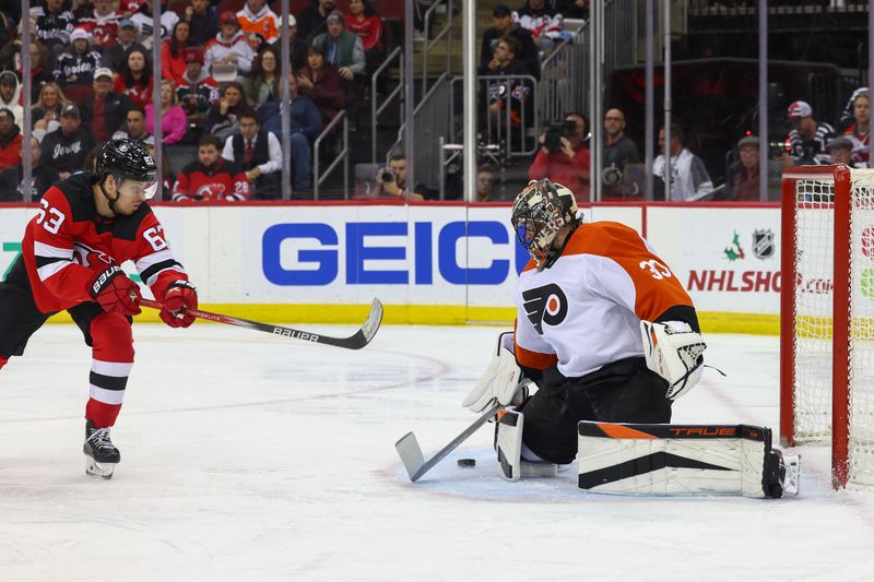 Dec 19, 2023; Newark, New Jersey, USA; Philadelphia Flyers goaltender Samuel Ersson (33) makes a save on New Jersey Devils left wing Jesper Bratt (63) during the second period at Prudential Center. Mandatory Credit: Ed Mulholland-USA TODAY Sports