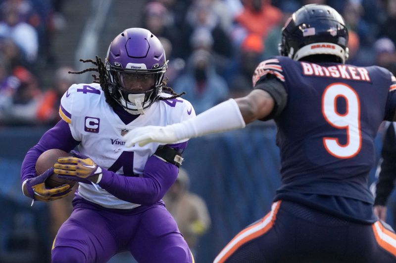 FILE - Minnesota Vikings running back Dalvin Cook runs against the Chicago Bears during the first half of an NFL football game on Jan. 8, 2023, in Chicago. The Minnesota Vikings are parting ways with the star running back for salary cap savings after his fourth consecutive season surpassing the 1,000-yard rushing mark. Cook has been informed he will be released, a person familiar with the team’s decision told The Associated Press on Thursday, June 8. (AP Photo/Nam Y. Huh, File)