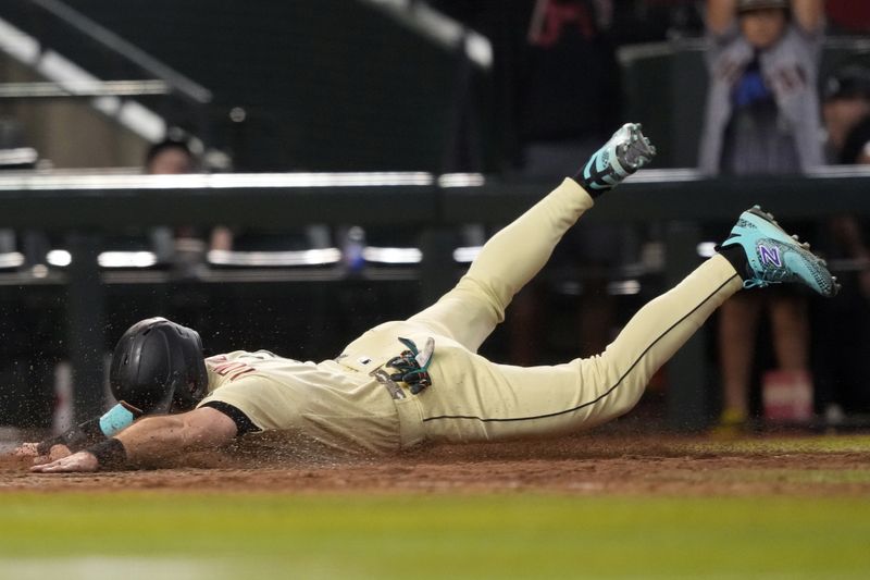 Sep 16, 2023; Phoenix, Arizona, USA; Arizona Diamondbacks pinch hitter Evan Longoria (3) slides at home and scores the game winning run against the Chicago Cubs during the 13th inning at Chase Field. Mandatory Credit: Joe Camporeale-USA TODAY Sports