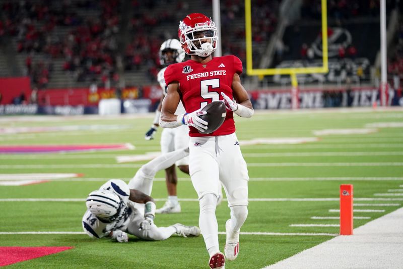 Sep 30, 2023; Fresno, California, USA; Fresno State Bulldogs wide receiver Jaelen Gill (5) scores a touchdown in front of Nevada Wolf Pack defensive back Devin Gunter (14) in the fourth quarter at Valley Children's Stadium. Mandatory Credit: Cary Edmondson-USA TODAY Sports