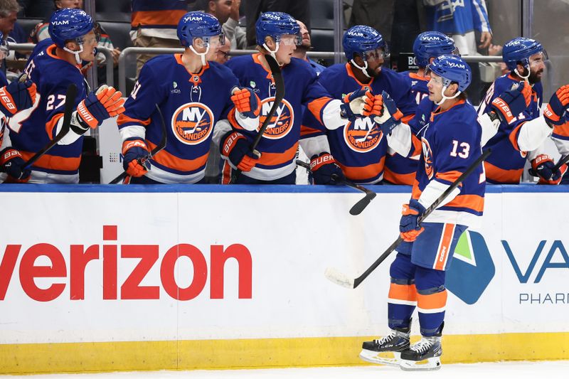 Oct 16, 2025; Elmont, New York, USA; New York Islanders center Mathew Barzal (13) celebrates with his teammates after scoring a goal in the first period against the Edmonton Oilers at UBS Arena. Mandatory Credit: Wendell Cruz-Imagn Images