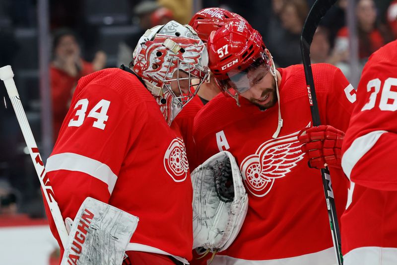 Jan 25, 2024; Detroit, Michigan, USA;  Detroit Red Wings goaltender Alex Lyon (34) receives congratulations from left wing David Perron (57) after the game against the Philadelphia Flyers at Little Caesars Arena. Mandatory Credit: Rick Osentoski-USA TODAY Sports