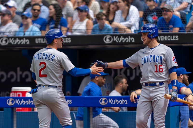 Aug 13, 2023; Toronto, Ontario, CAN; Chicago Cubs second baseman Nico Hoerner (2) celebrates with teammate third baseman Patrick Wisdom (16) scoring against the Toronto Blue Jays during the first inning at Rogers Centre. Mandatory Credit: Kevin Sousa-USA TODAY Sports