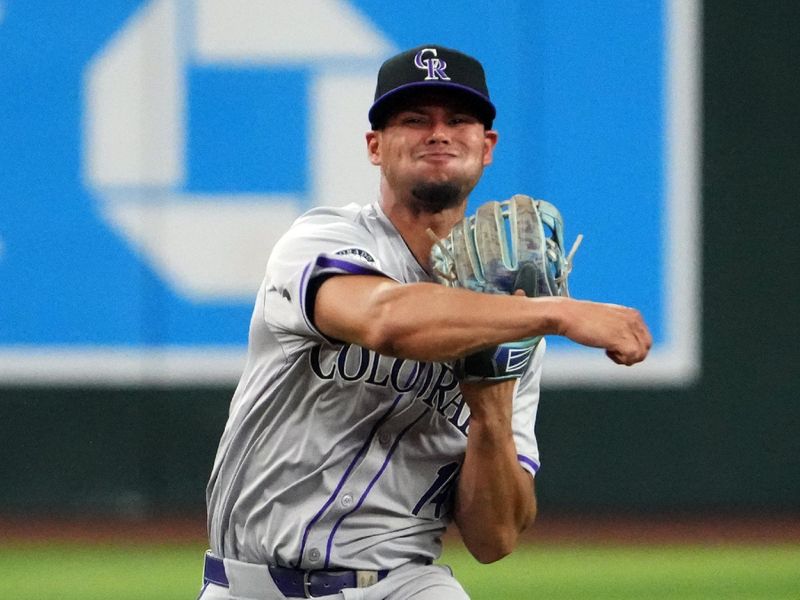 Aug 13, 2024; Phoenix, Arizona, USA; Colorado Rockies shortstop Ezequiel Tovar (14) throws to first base against the Arizona Diamondbacks during the third inning at Chase Field. Mandatory Credit: Joe Camporeale-USA TODAY Sports