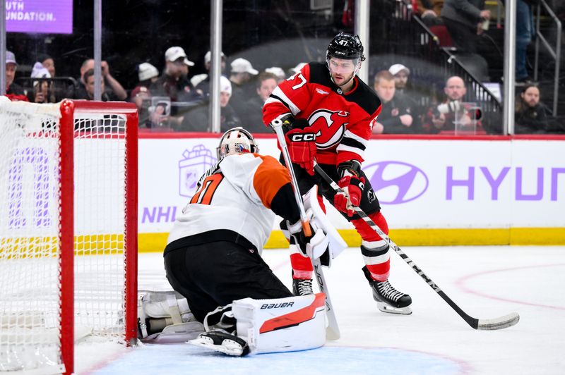 Nov 29, 2025; Newark, New Jersey, USA; New Jersey Devils left wing Paul Cotter (47) tries to rebound the puck as Philadelphia Flyers goaltender Dan Vladar (80) defends during the second period at Prudential Center. Mandatory Credit: John Jones-Imagn Images