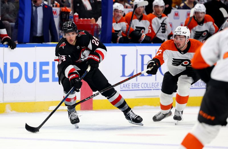 Nov 3, 2023; Buffalo, New York, USA;  Philadelphia Flyers left wing Noah Cates (27) tries to block a pass by Buffalo Sabres center Dylan Cozens (24) during the second period at KeyBank Center. Mandatory Credit: Timothy T. Ludwig-USA TODAY Sports