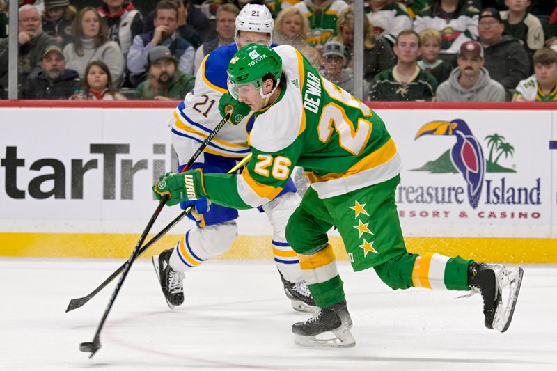 Feb 17, 2024; Saint Paul, Minnesota, USA;  Minnesota Wild forward Connor Dewar (26) clears the puck on a penalty kill against the Buffalo Sabres during the first period at Xcel Energy Center. Mandatory Credit: Nick Wosika-USA TODAY Sports