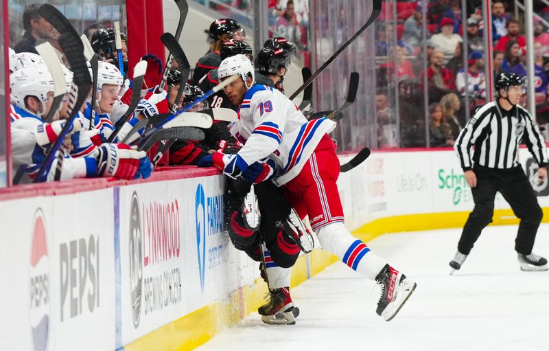 Nov 27, 2024; Raleigh, North Carolina, USA;  New York Rangers defenseman K'Andre Miller (79) checks Carolina Hurricanes right wing Jackson Blake (53) during the third period at Lenovo Center. Mandatory Credit: James Guillory-Imagn Images