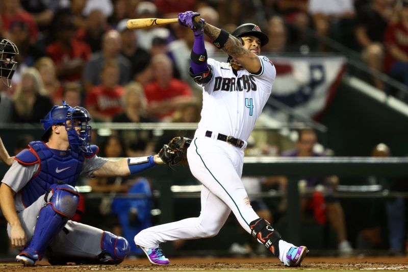 Oct 11, 2023; Phoenix, Arizona, USA; Arizona Diamondbacks second baseman Ketel Marte (4) hits a home run against the Los Angeles Dodgers in the third inning for game three of the NLDS for the 2023 MLB playoffs at Chase Field. Mandatory Credit: Mark J. Rebilas-USA TODAY Sports