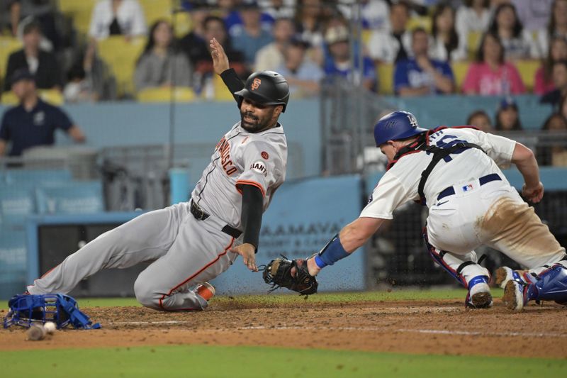 Jul 24, 2024; Los Angeles, California, USA;  Los Angeles Dodgers catcher Will Smith (16) misses the tag on San Francisco Giants first baseman LaMonte Wade Jr. (31) as he scores a run in the eighth inning at Dodger Stadium. Mandatory Credit: Jayne Kamin-Oncea-USA TODAY Sports
