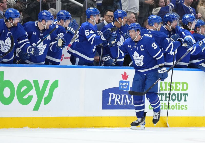 Apr 13, 2024; Toronto, Ontario, CAN; Toronto Maple Leafs center John Tavares (91) celebrates at the bench after scoring a goal against the Detroit Red Wings during the second period at Scotiabank Arena. Mandatory Credit: Nick Turchiaro-USA TODAY Sports