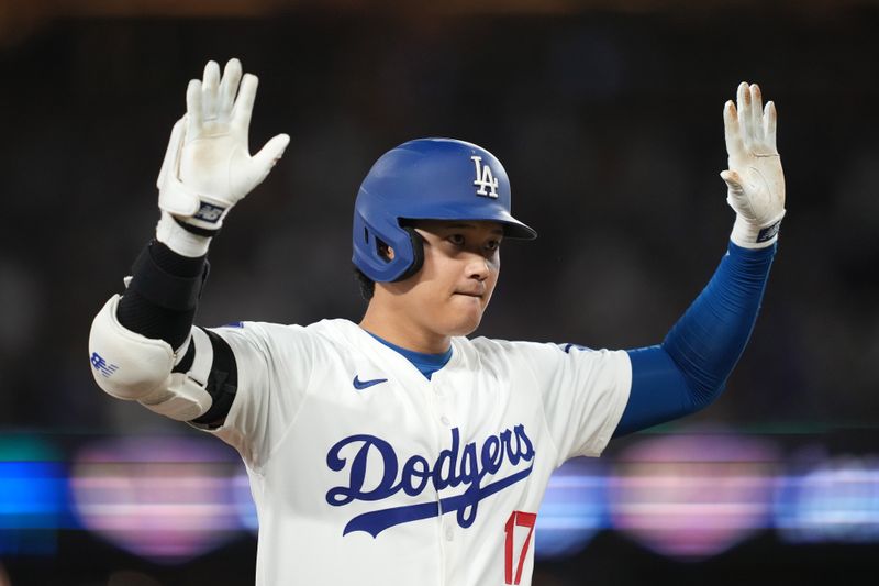 Aug 20, 2024; Los Angeles, California, USA; Los Angeles Dodgers designated hitter Shohei Ohtani (17) reacts after hitting a triple in the third inning against the Seattle Mariners at Dodger Stadium. Mandatory Credit: Kirby Lee-USA TODAY Sports