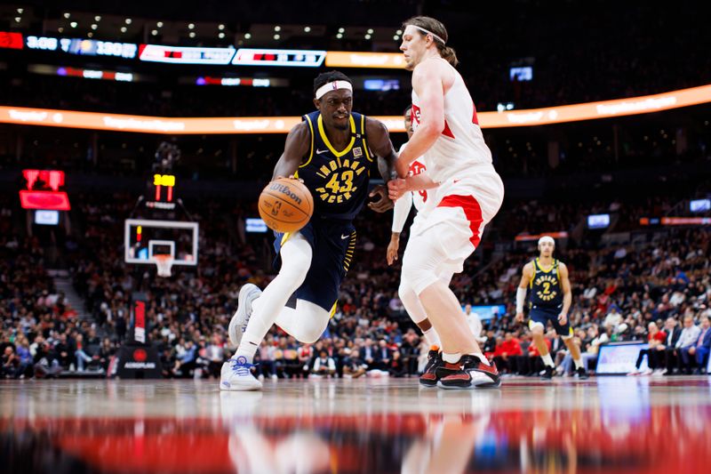 TORONTO, CANADA - APRIL 9: Pascal Siakam #43 of the Indiana Pacers drives to the net against Kelly Olynyk #41 of the Toronto Raptors during the second half of their NBA game at Scotiabank Arena on April 9, 2024 in Toronto, Canada. NOTE TO USER: User expressly acknowledges and agrees that, by downloading and or using this photograph, User is consenting to the terms and conditions of the Getty Images License Agreement. (Photo by Cole Burston/Getty Images)