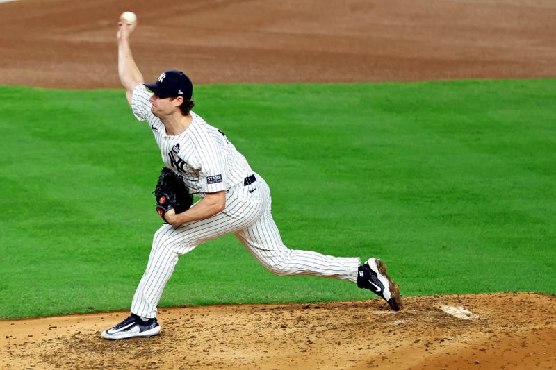 Oct 30, 2024; Bronx, New York, USA; New York Yankees pitcher Gerrit Cole (45) pitches against the Los Angeles Dodgers during game five of the 2024 MLB World Series at Yankee Stadium. Mandatory Credit: James Lang-Imagn Images