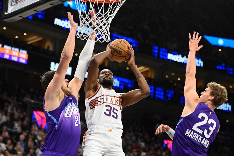 SALT LAKE CITY, UTAH - DECEMBER 13: Kevin Durant #35 of the Phoenix Suns shoots between Walker Kessler #24 and Lauri Markkanen #23 of the Utah Jazz during the second half of a game at Delta Center on December 13, 2024 in Salt Lake City, Utah.  NOTE TO USER: User expressly acknowledges and agrees that, by downloading and or using this photograph, User is consenting to the terms and conditions of the Getty Images License Agreement. (Photo by Alex Goodlett/Getty Images)