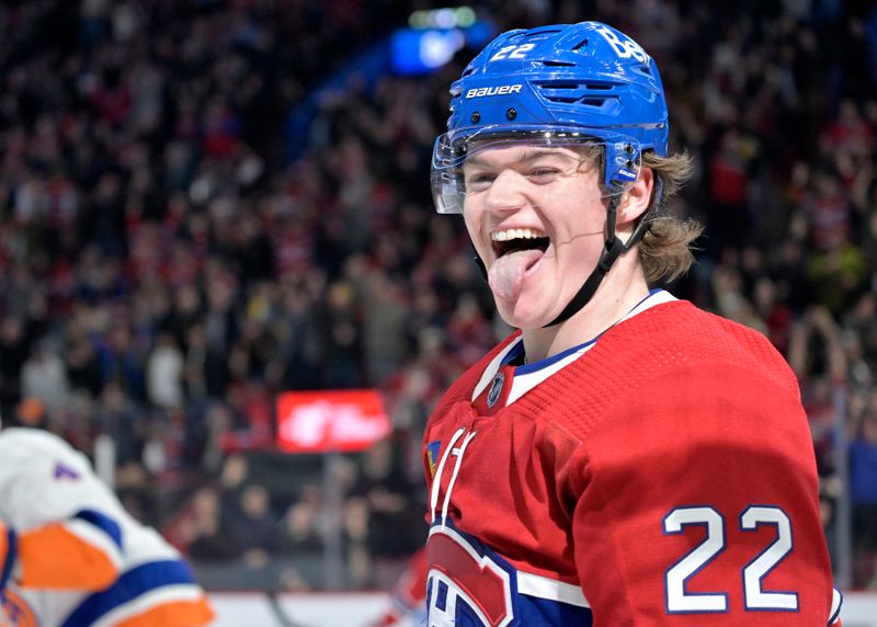 Jan 25, 2024; Montreal, Quebec, CAN; Montreal Canadiens forward Cole Caufield (22) celebrates after scoring a goal against the New York Islanders during the first period at the Bell Centre. Mandatory Credit: Eric Bolte-USA TODAY Sports