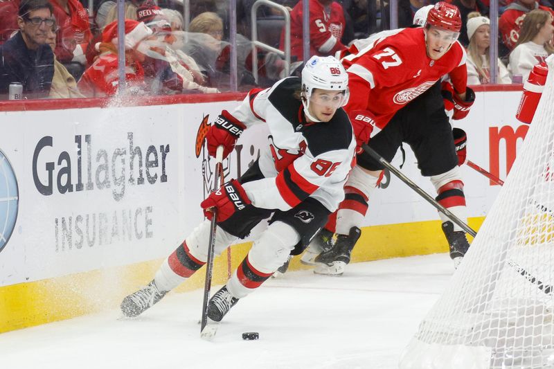 Nov 29, 2024; Detroit, Michigan, USA; New Jersey Devils center Jack Hughes (86) handles the puck behind the net during the third period against the Detroit Red Wings at Little Caesars Arena. Mandatory Credit: Brian Bradshaw Sevald-Imagn Images