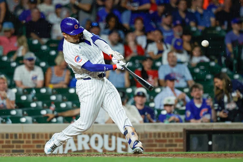 Aug 1, 2024; Chicago, Illinois, USA; Chicago Cubs outfielder Seiya Suzuki (27) hits a solo home run against the St. Louis Cardinals during the sixth inning at Wrigley Field. Mandatory Credit: Kamil Krzaczynski-USA TODAY Sports