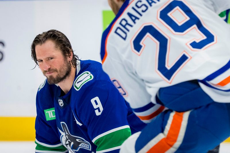 May 20, 2024; Vancouver, British Columbia, CAN; Vancouver Canucks forward J.T. Miller (9) watches Edmonton Oilers forward Leon Draisaitl (29) in warm up prior to game seven of the second round of the 2024 Stanley Cup Playoffs at Rogers Arena. Mandatory Credit: Bob Frid-USA TODAY Sports