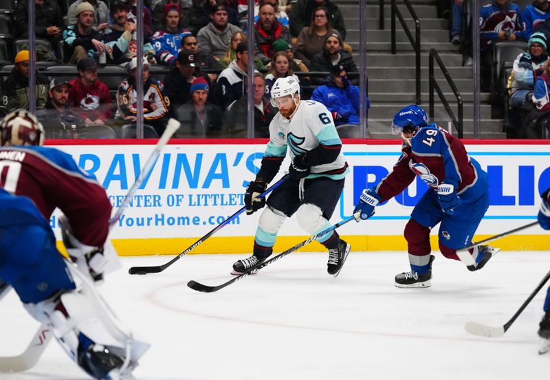 Nov 5, 2024; Denver, Colorado, USA; Colorado Avalanche defenseman Samuel Girard (49) defends against Seattle Kraken defenseman Adam Larsson (6) in the third period at Ball Arena. Mandatory Credit: Ron Chenoy-Imagn Images