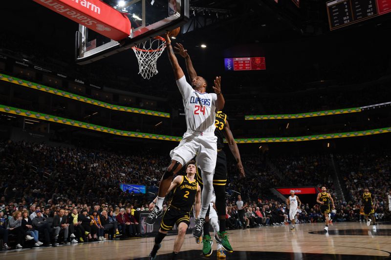 SAN FRANCISCO, CA - FEBRUARY 14: Norman Powell #24 of the LA Clippers drives to the basket during the game against the Golden State Warriors on FEBRUARY 14, 2024 at Chase Center in San Francisco, California. NOTE TO USER: User expressly acknowledges and agrees that, by downloading and or using this photograph, user is consenting to the terms and conditions of Getty Images License Agreement. Mandatory Copyright Notice: Copyright 2024 NBAE (Photo by Noah Graham/NBAE via Getty Images)