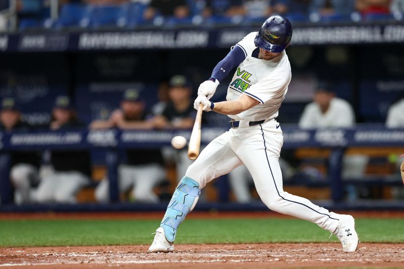 Jul 12, 2024; St. Petersburg, Florida, USA; Tampa Bay Rays designated hitter Brandon Lowe (8) singles against the Cleveland Guardians in the seventh inning at Tropicana Field. Mandatory Credit: Nathan Ray Seebeck-USA TODAY Sports