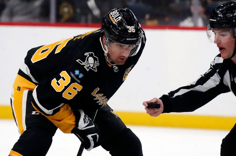 Feb 18, 2024; Pittsburgh, Pennsylvania, USA;  Pittsburgh Penguins center Colin White (36) eyes the puck on a face-off against the Los Angeles Kings during the third period at PPG Paints Arena. Los Angeles won 2-1. Mandatory Credit: Charles LeClaire-USA TODAY Sports