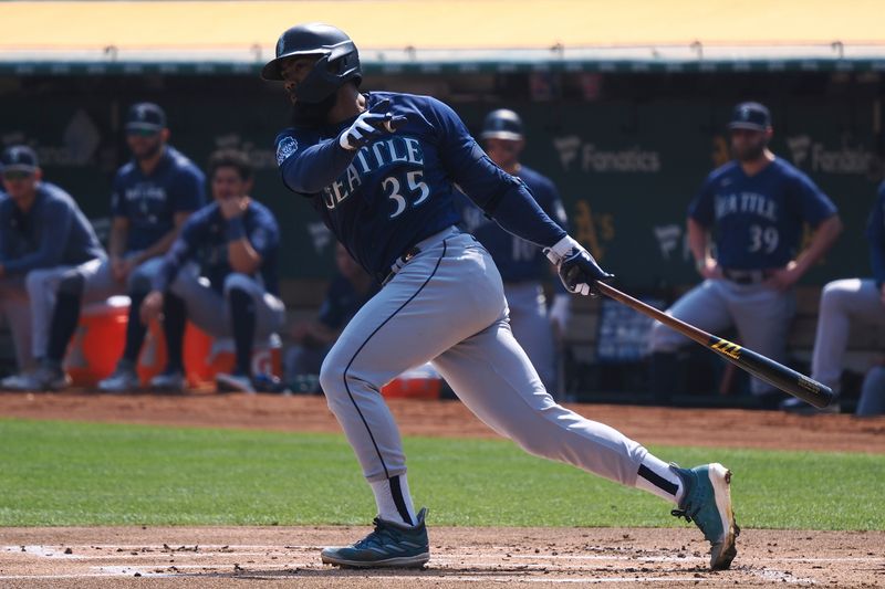 Sep 20, 2023; Oakland, California, USA; Seattle Mariners designated hitter Teoscar Hernandez (35) hits a single against the Oakland Athletics during the first inning at Oakland-Alameda County Coliseum. Mandatory Credit: Kelley L Cox-USA TODAY Sports