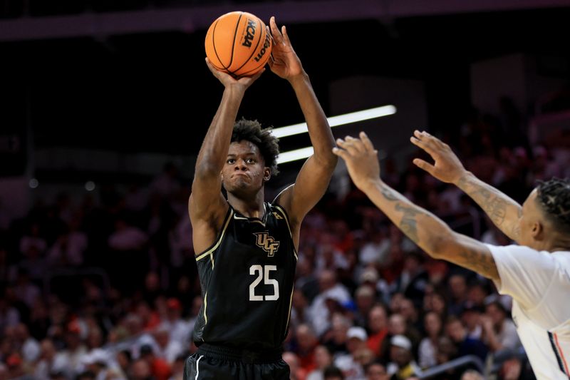 Feb 4, 2023; Cincinnati, Ohio, USA;  UCF Knights forward Taylor Hendricks (25) attempts a three-point basket against Cincinnati Bearcats guard Landers Nolley II (2) in the second half at Fifth Third Arena. Mandatory Credit: Aaron Doster-USA TODAY Sports