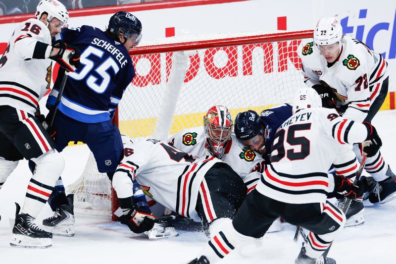 Mar 3, 2026; Winnipeg, Manitoba, CAN;  Winnipeg Jets forward Mark Scheifele (55),Chicago Blackhawks forward Jason Dickinson (16), Chicago Blackhawks defenseman Alex Vlasic (72) Winnipeg Jets forward Alex Iafallo (9) and Chicago Blackhawks goalie Spencer Knight (30) scramble for the puck during the third period at Canada Life Centre. Mandatory Credit: Terrence Lee-Imagn Images