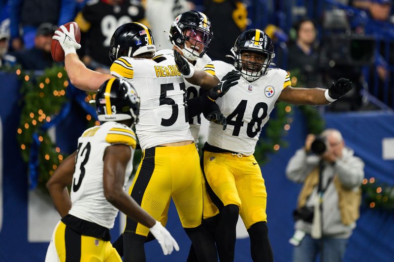 Pittsburgh Steelers linebacker Nick Herbig (51) and Pittsburgh Steelers running back Godwin Igwebuike (48) celebrate a blocked punt during an NFL football game against the Indianapolis Colts, Saturday, Dec. 16, 2023, in Indianapolis. (AP Photo/Zach Bolinger)