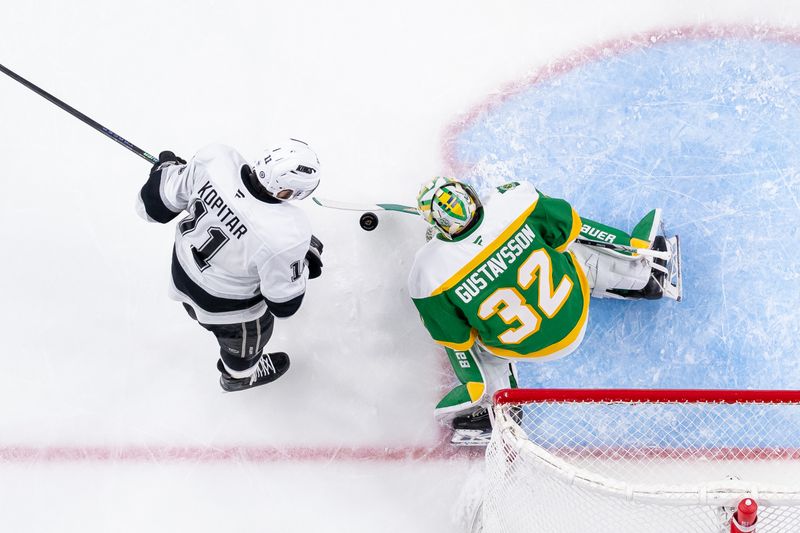 Mar 17, 2025; Saint Paul, Minnesota, USA;  Minnesota Wild goaltender Filip Gustavsson (32) makes a save against the Los Angeles Kings center Anze Kopitar (11) in the second period at Xcel Energy Center. Mandatory Credit: Brad Rempel-Imagn Images