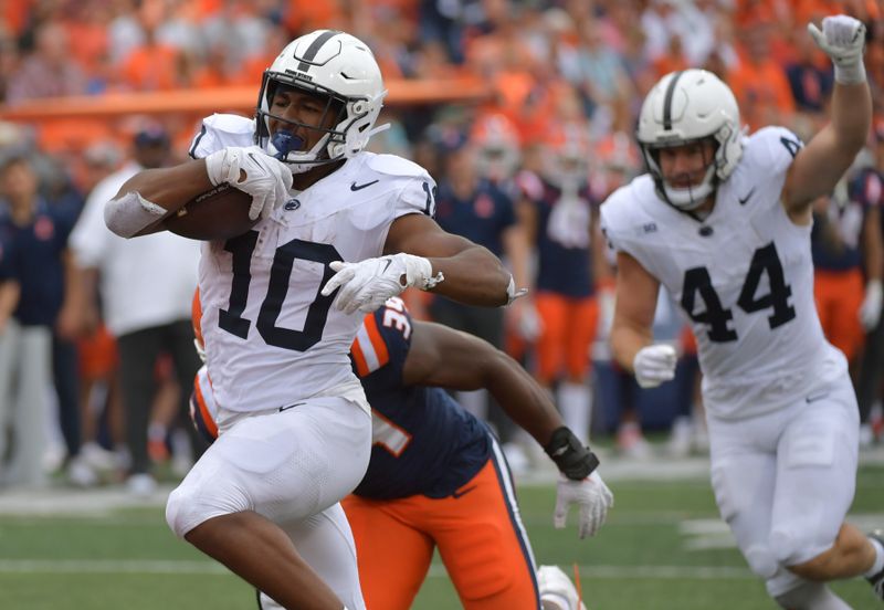 Sep 16, 2023; Champaign, Illinois, USA;  Penn State Nittany Lions running back Nicholas Singleton (10) scores a touchdown against the Illinois Fighting Illini during the second half at Memorial Stadium. Mandatory Credit: Ron Johnson-USA TODAY Sports