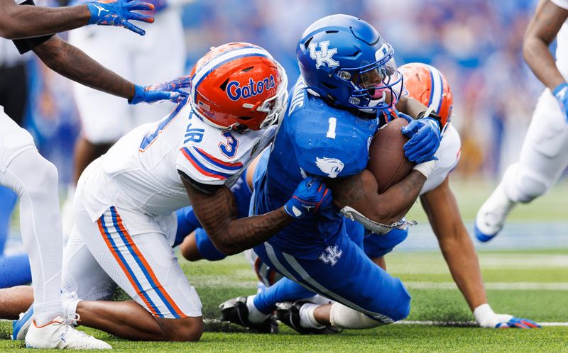 Sep 30, 2023; Lexington, Kentucky, USA; Kentucky Wildcats running back Ray Davis (1) is brought down by Florida Gators cornerback Jason Marshall Jr. (3) during the fourth quarter at Kroger Field. Mandatory Credit: Jordan Prather-USA TODAY Sports