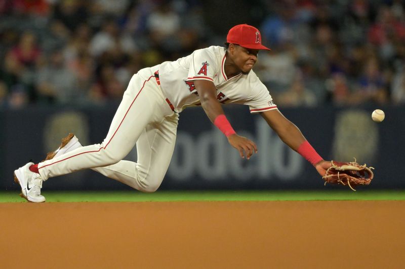 Sep 23, 2025; Anaheim, California, USA;  Los Angeles Angels shortstop Denzer Guzman (13) can’t reach a double by Kansas City Royals third baseman Maikel Garcia (11) during the fifth inning tat Angel Stadium. Mandatory Credit: Jayne Kamin-Oncea-Imagn Images