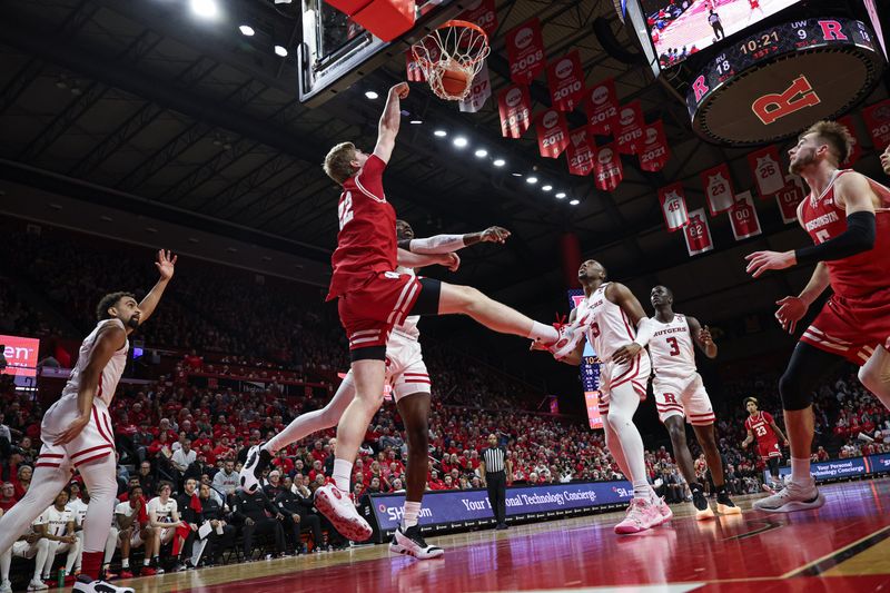 Feb 10, 2024; Piscataway, New Jersey, USA; Wisconsin Badgers forward Steven Crowl (22) dunks the ball in front of Rutgers Scarlet Knights center Clifford Omoruyi (11) and forward Aundre Hyatt (5) during the first half at Jersey Mike's Arena. Mandatory Credit: Vincent Carchietta-USA TODAY Sports