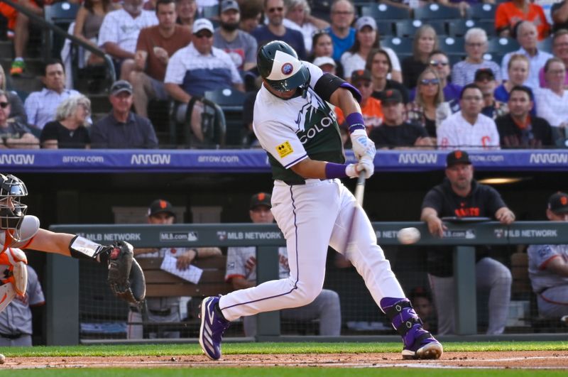 Jul 20, 2024; Denver, Colorado, USA;  Colorado Rockies shortstop Ezequiel Tovar (14) gets a base hit against the San Francisco Giants in the first inning at Coors Field. Mandatory Credit: John Leyba-USA TODAY Sports