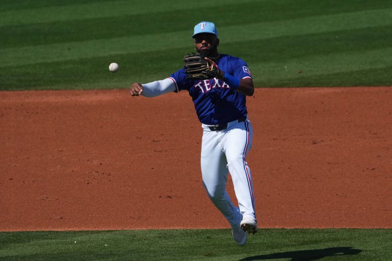 Mar 8, 2024; Surprise, Arizona, USA; Texas Rangers shortstop Ezequiel Duran (20) throws to first base against the Kansas City Royals during the third inning at Surprise Stadium. Mandatory Credit: Joe Camporeale-USA TODAY Sports