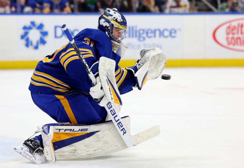 Mar 9, 2023; Buffalo, New York, USA;  Buffalo Sabres goaltender Eric Comrie (31) makes a glove save during the third period against the Dallas Stars at KeyBank Center. Mandatory Credit: Timothy T. Ludwig-USA TODAY Sports